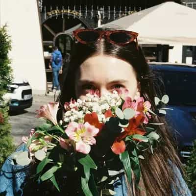 Woman holding a colourful bouquet of fresh flowers